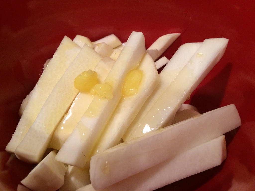 Coat turnip strips with coconut oil.